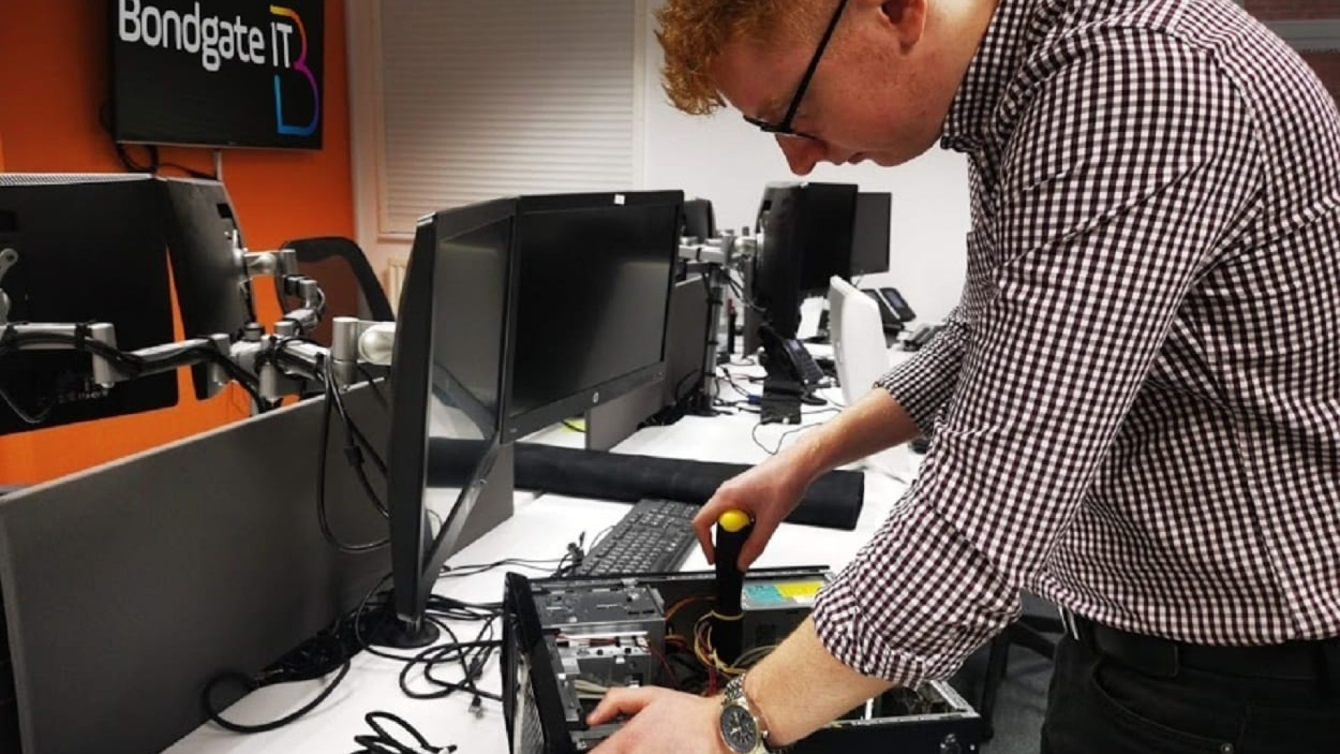 Adam Pevie of Bondgate IT refurbishes one of the computers due to be donated