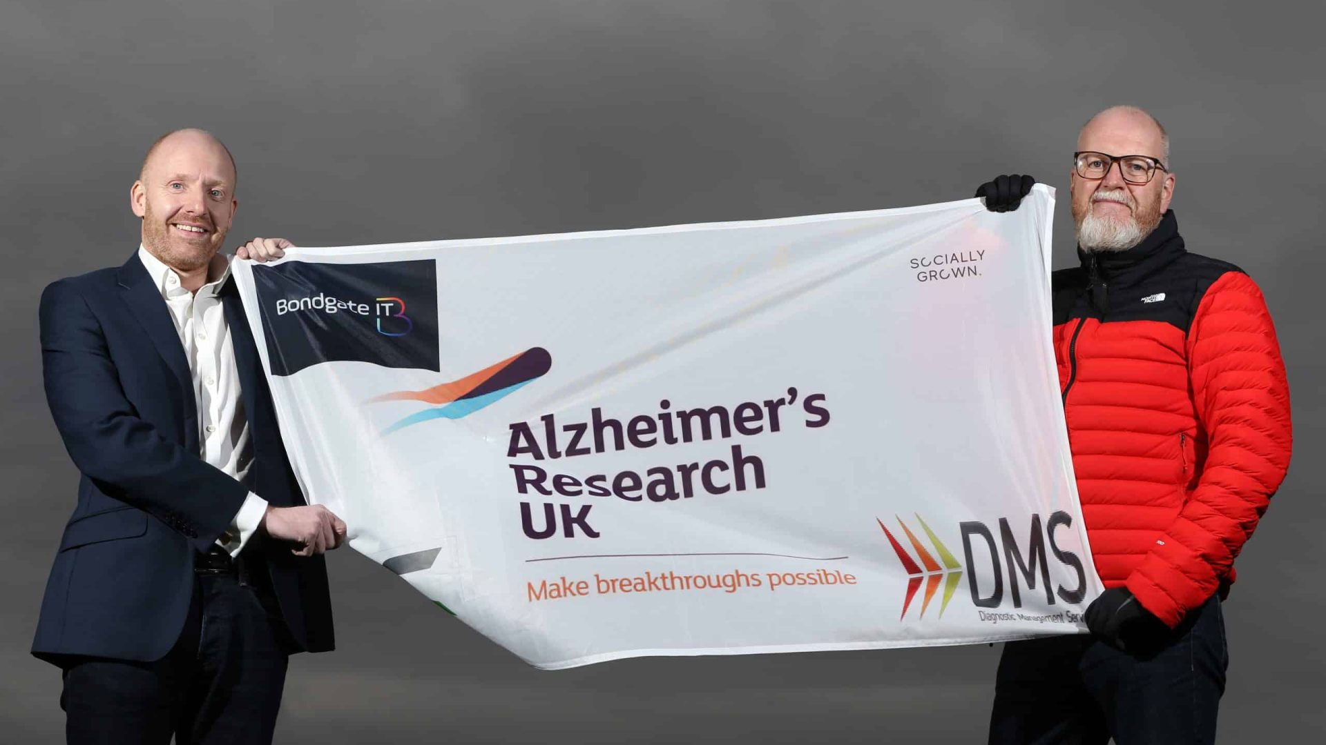Garry Brown and Mitchell Smith with the flag he will unfurl at Everest Base Camp