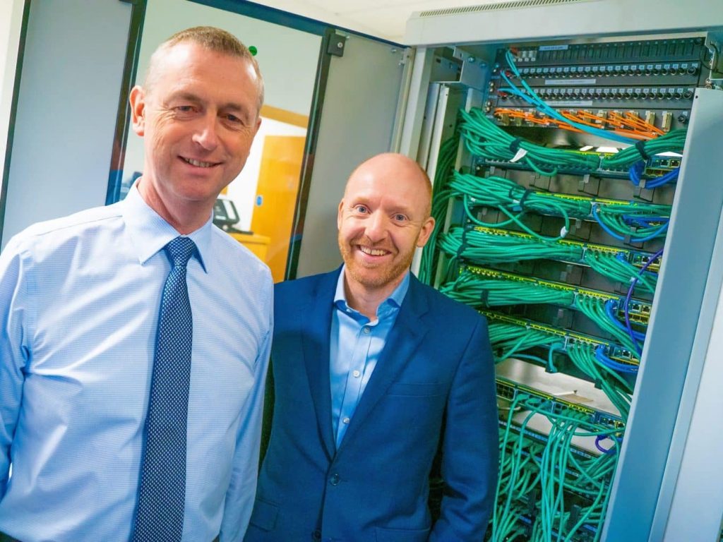 John Tinkler and Garry Brown standing to servers