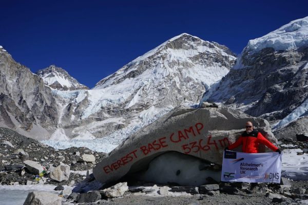Mitchell Smith displays the flag at Everest Base Camp