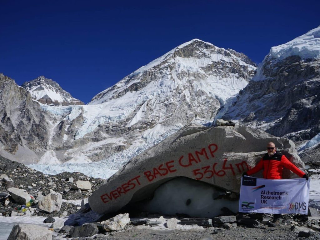 Mitchell Smith displays the flag at Everest Base Camp